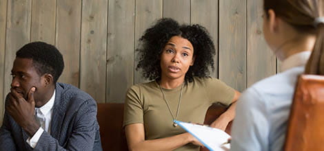 Couple talking to doctor